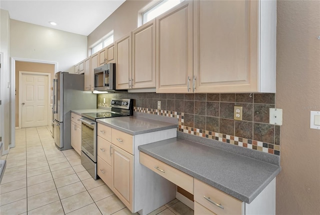 10263 Shadow Run Cir, Punta Gorda, FL 33955 - kitchen with stainless steel appliances, light tile patterned flooring, and tasteful backsplash