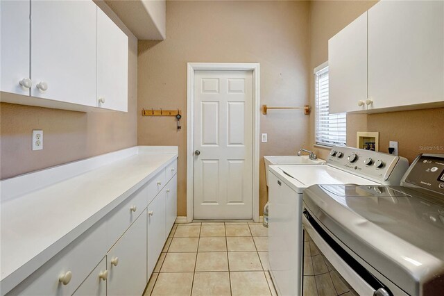 10263 Shadow Run Cir, Punta Gorda, FL 33955 - laundry room with washing machine and dryer, cabinet space, and light tile patterned flooring