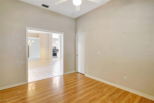 10263 Shadow Run Cir, Punta Gorda, FL 33955 - spare room featuring a ceiling fan, light wood-type flooring, a chandelier, and baseboards