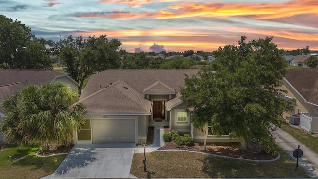 1876 Birmingham Blvd, Punta Gorda, FL 33980 - view of front of house featuring concrete driveway, a garage, central AC, and stucco siding