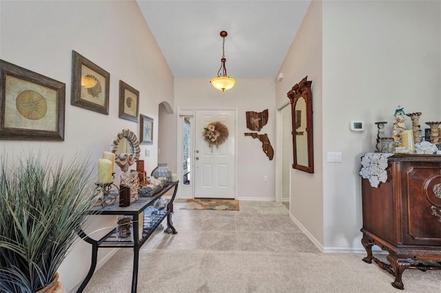 1876 Birmingham Blvd, Punta Gorda, FL 33980 - foyer featuring arched walkways, baseboards, and light carpet