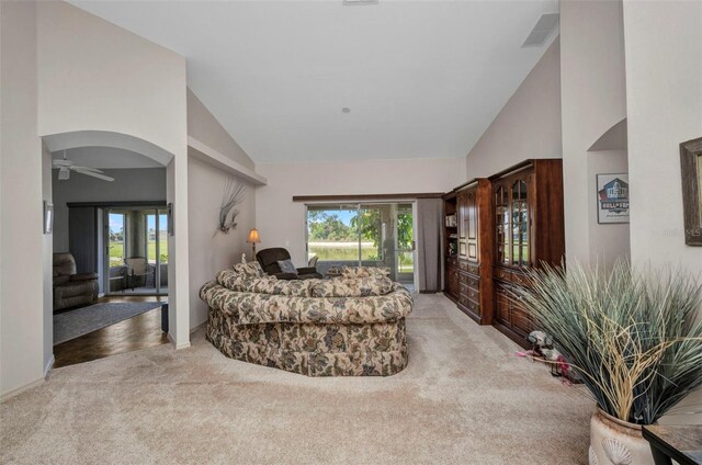 1876 Birmingham Blvd, Punta Gorda, FL 33980 - carpeted living area featuring high vaulted ceiling, plenty of natural light, ceiling fan, and baseboards