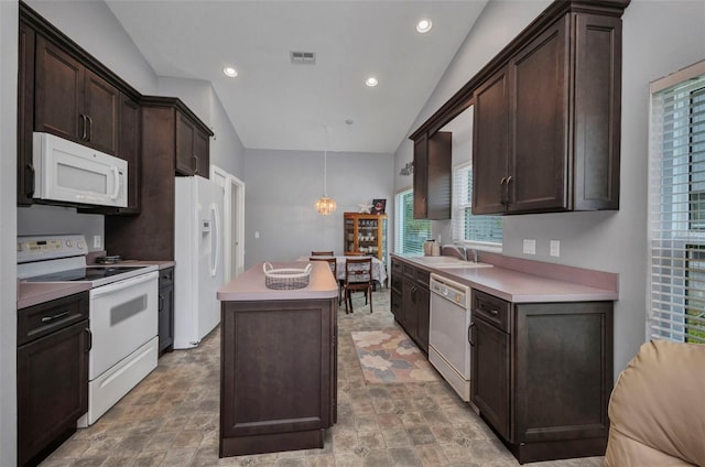 1876 Birmingham Blvd, Punta Gorda, FL 33980 - kitchen featuring white appliances, a kitchen island, dark brown cabinetry, a sink, and lofted ceiling