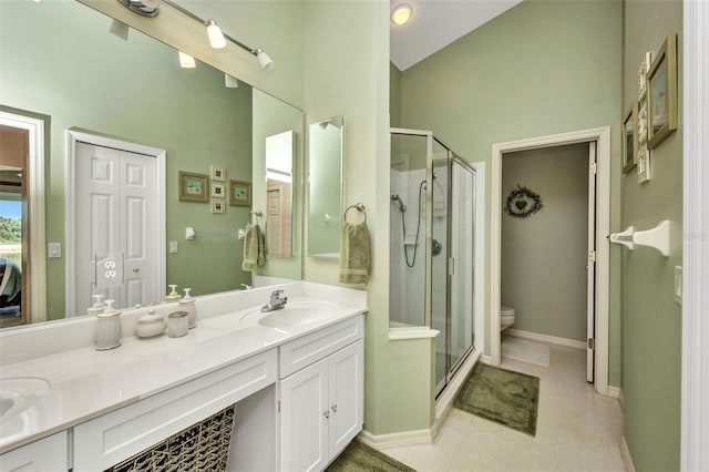 1876 Birmingham Blvd, Punta Gorda, FL 33980 - bathroom with double vanity, toilet, a stall shower, tile patterned flooring, and baseboards