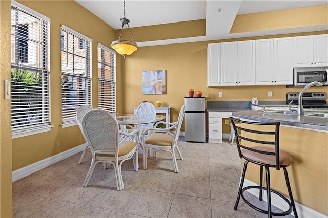99 Vivante Blvd Unit 310, Punta Gorda, FL 33950 - dining room featuring baseboards and light tile patterned flooring
