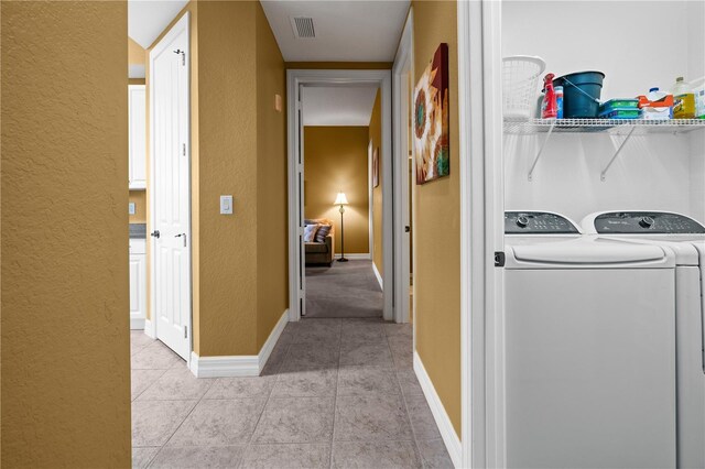 99 Vivante Blvd Unit 310, Punta Gorda, FL 33950 - laundry area with washer and dryer, a textured wall, light tile patterned flooring, and baseboards