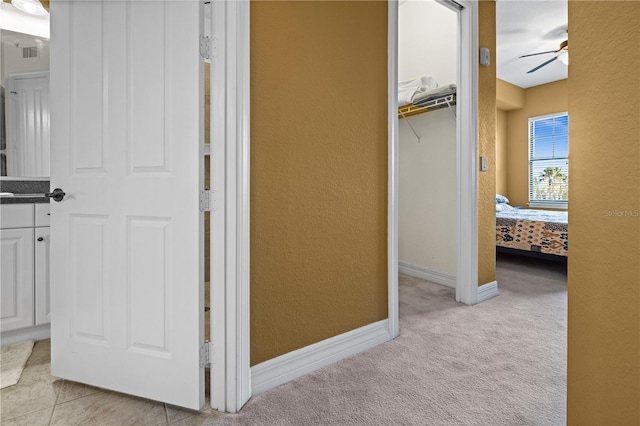 99 Vivante Blvd Unit 310, Punta Gorda, FL 33950 - hallway with light colored carpet, a textured wall, and baseboards