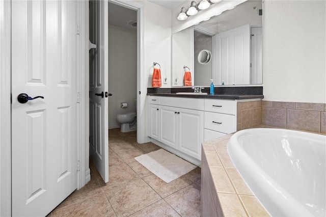 99 Vivante Blvd Unit 310, Punta Gorda, FL 33950 - bathroom featuring vanity, a bath, toilet, and tile patterned floors
