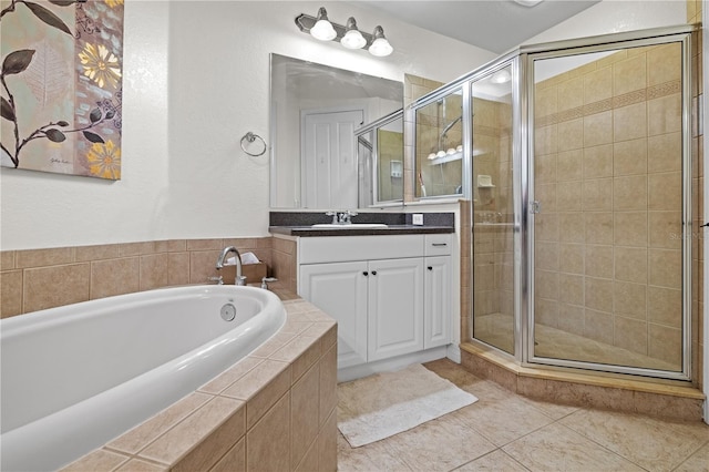 99 Vivante Blvd Unit 310, Punta Gorda, FL 33950 - bathroom featuring vanity, a garden tub, a stall shower, and tile patterned floors