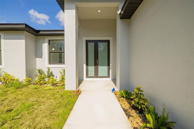 355 Milton St, Port Charlotte, FL 33954 - doorway to property featuring stucco siding and french doors