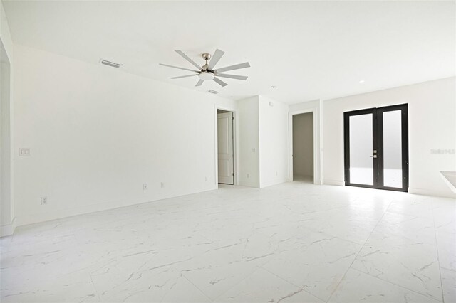 355 Milton St, Port Charlotte, FL 33954 - empty room featuring french doors, ceiling fan, light marble finish floors, and baseboards