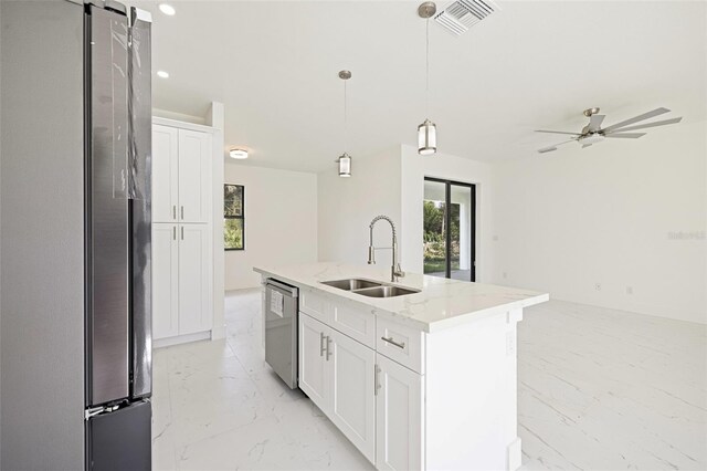 355 Milton St, Port Charlotte, FL 33954 - kitchen featuring stainless steel appliances, a sink, light marble finish flooring, white cabinets, and light stone countertops