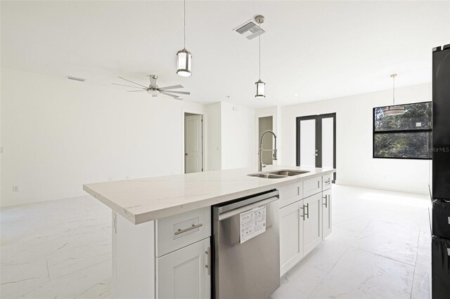 355 Milton St, Port Charlotte, FL 33954 - kitchen with dishwasher, a sink, light marble finish flooring, a kitchen island with sink, and light stone counters
