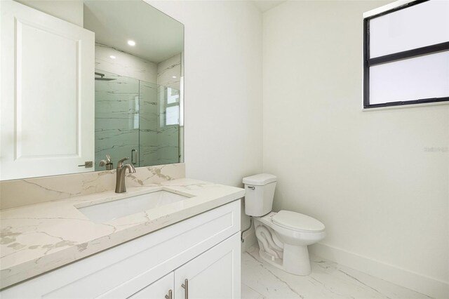 355 Milton St, Port Charlotte, FL 33954 - bathroom featuring marble look tile flooring, a marble finish shower, toilet, vanity, and baseboards