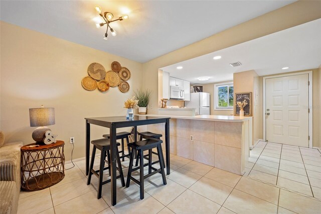 12538 SW Kingsway Cir Unit 1503, Lake Suzy, FL 34269 - dining area with light tile patterned flooring, baseboards, and recessed lighting