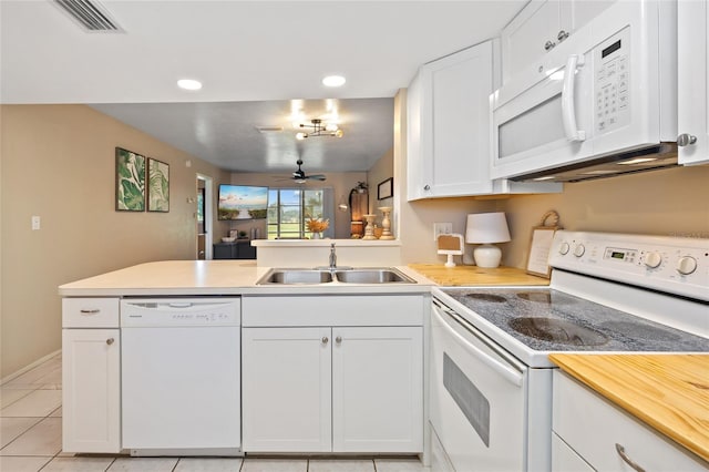 12538 SW Kingsway Cir Unit 1503, Lake Suzy, FL 34269 - kitchen featuring white appliances, a sink, a peninsula, white cabinetry, and light countertops