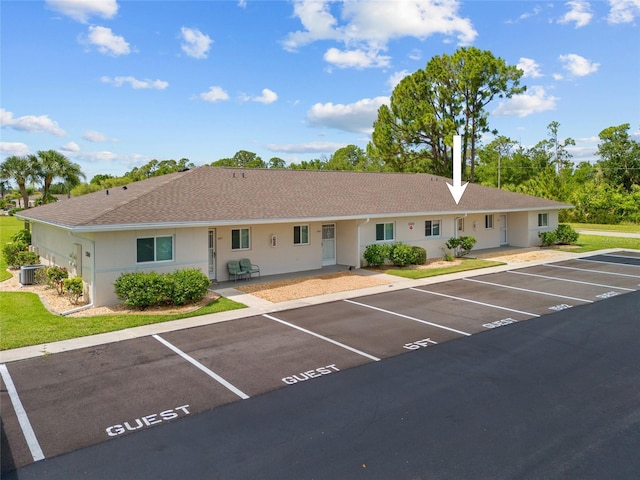 12538 SW Kingsway Cir Unit 1503, Lake Suzy, FL 34269 - view of front of house with uncovered parking, central AC, stucco siding, and roof with shingles
