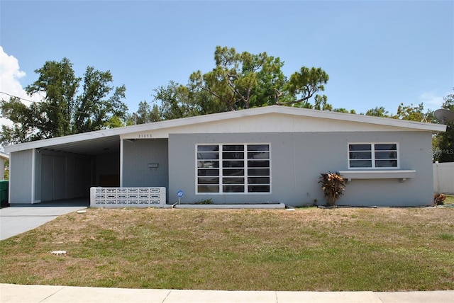 21275 Austin Ave, Port Charlotte, FL 33952 - view of front of home featuring a front yard, an attached carport, and concrete driveway