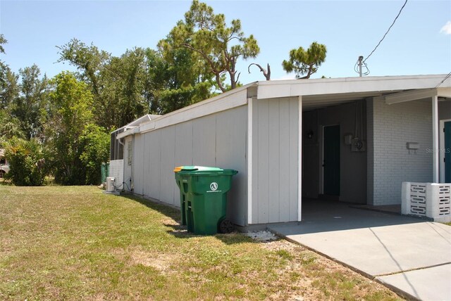 21275 Austin Ave, Port Charlotte, FL 33952 - view of side of property with brick siding and a yard