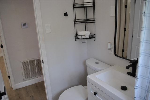 21275 Austin Ave, Port Charlotte, FL 33952 - bathroom featuring toilet, vanity, and wood finished floors