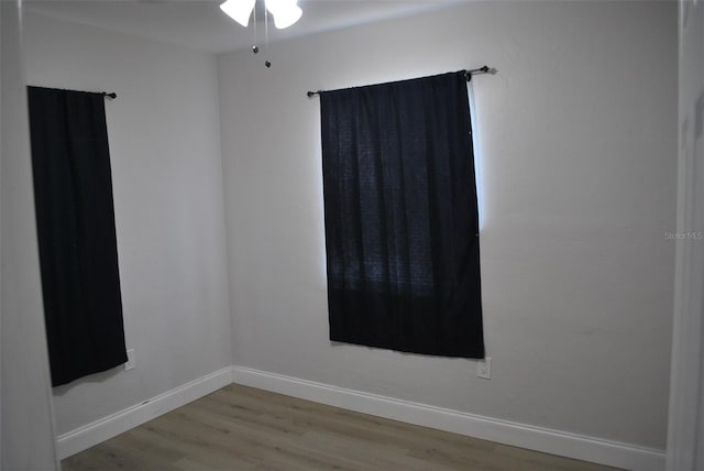 21275 Austin Ave, Port Charlotte, FL 33952 - spare room with wood finished floors, a ceiling fan, and baseboards