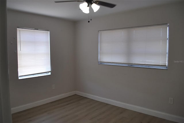 21275 Austin Ave, Port Charlotte, FL 33952 - unfurnished room featuring a ceiling fan, wood finished floors, and baseboards