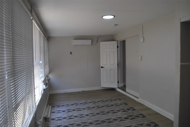 21275 Austin Ave, Port Charlotte, FL 33952 - corridor with a wall unit AC, wood finished floors, and baseboards