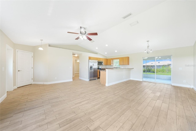 11615 SW Pine Ave, Arcadia, FL 34269 - unfurnished living room featuring ceiling fan, lofted ceiling, a chandelier, light wood-type flooring, and baseboards