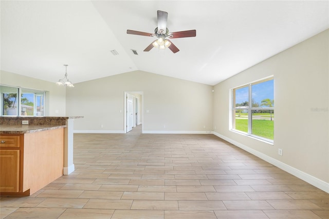 11615 SW Pine Ave, Arcadia, FL 34269 - unfurnished living room featuring a ceiling fan, lofted ceiling, plenty of natural light, a chandelier, and baseboards