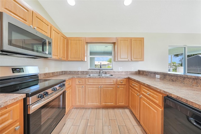 11615 SW Pine Ave, Arcadia, FL 34269 - kitchen featuring appliances with stainless steel finishes, a sink, light brown cabinetry, vaulted ceiling, and wood tiled floors