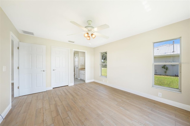 11615 SW Pine Ave, Arcadia, FL 34269 - unfurnished bedroom featuring light wood finished floors, baseboards, and multiple windows