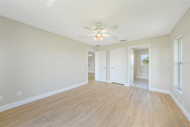 11615 SW Pine Ave, Arcadia, FL 34269 - unfurnished bedroom with light wood finished floors, baseboards, ensuite bathroom, and a ceiling fan