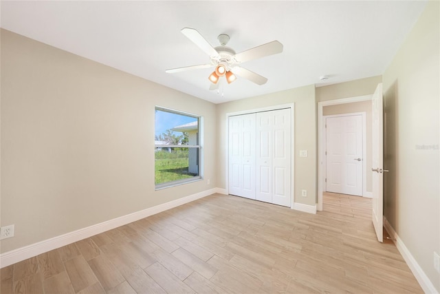 11615 SW Pine Ave, Arcadia, FL 34269 - unfurnished bedroom with light wood finished floors, a closet, baseboards, and ceiling fan