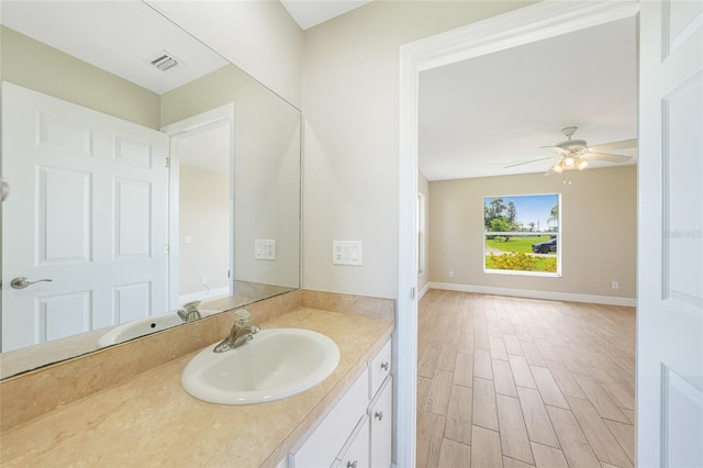 11615 SW Pine Ave, Arcadia, FL 34269 - bathroom with vanity, wood finished floors, a ceiling fan, and baseboards