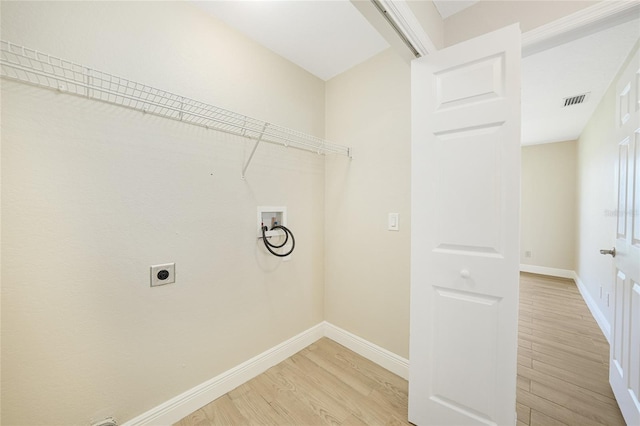 11615 SW Pine Ave, Arcadia, FL 34269 - washroom featuring electric dryer hookup, washer hookup, light wood-style floors, and baseboards