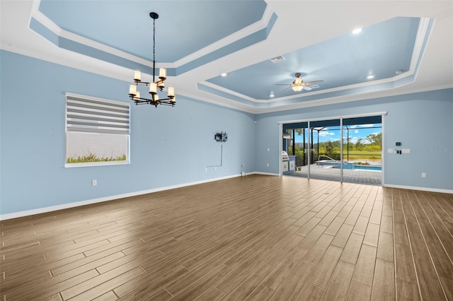 43406 Boardwalk Loop, Punta Gorda, FL 33982 - spare room with a tray ceiling, ornamental molding, dark wood-style flooring, baseboards, and ceiling fan