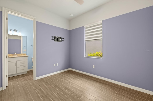 43406 Boardwalk Loop, Punta Gorda, FL 33982 - unfurnished bedroom with baseboards, light wood-style flooring, and a sink