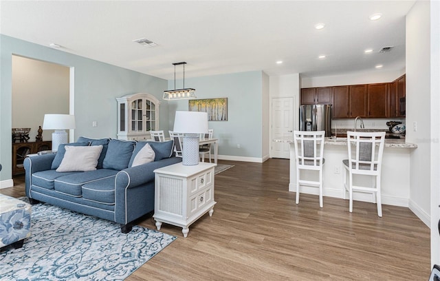 8866 Tuscany Isles Dr, Punta Gorda, FL 33950 - living area with light wood finished floors, baseboards, and recessed lighting