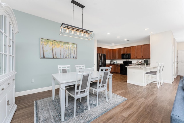 8866 Tuscany Isles Dr, Punta Gorda, FL 33950 - dining area with wood finished floors, baseboards, and recessed lighting