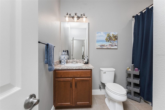 8866 Tuscany Isles Dr, Punta Gorda, FL 33950 - full bath with vanity, toilet, tile patterned floors, a shower with shower curtain, and baseboards