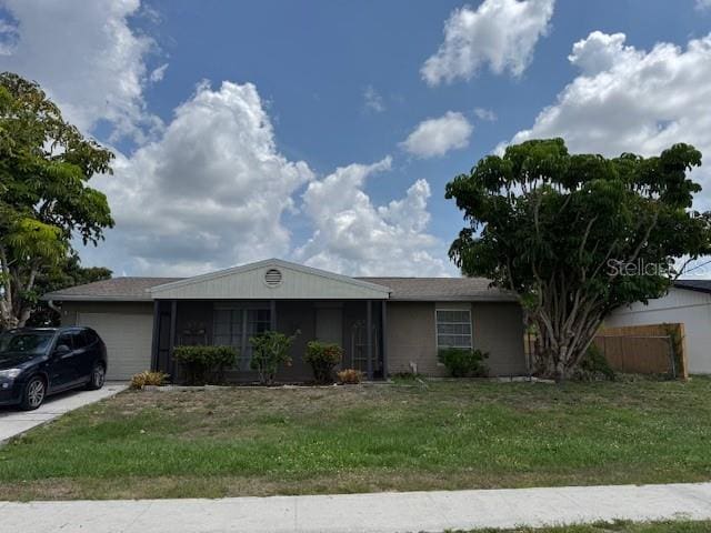 8158 Trionfo Ave, North Port, FL 34287 - ranch-style home featuring an attached garage and driveway