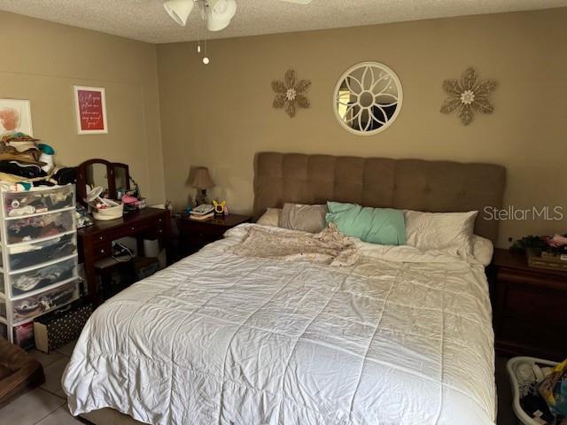 8158 Trionfo Ave, North Port, FL 34287 - bedroom featuring a textured ceiling and tile patterned floors