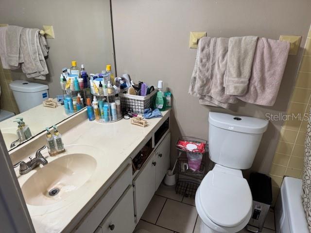 8158 Trionfo Ave, North Port, FL 34287 - bathroom with toilet, vanity, and tile patterned flooring