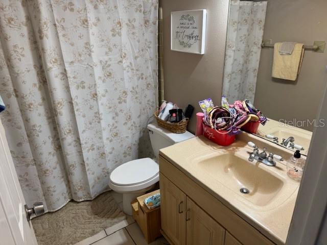 8158 Trionfo Ave, North Port, FL 34287 - full bathroom featuring toilet, vanity, and a shower with shower curtain