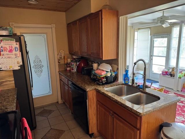 8158 Trionfo Ave, North Port, FL 34287 - kitchen featuring a sink, black appliances, a ceiling fan, brown cabinets, and light tile patterned floors
