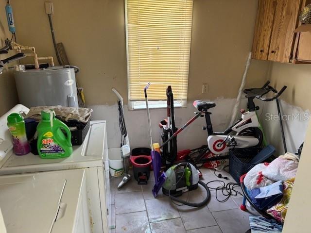 8158 Trionfo Ave, North Port, FL 34287 - laundry room featuring washer and dryer, electric water heater, tile patterned flooring, and cabinet space