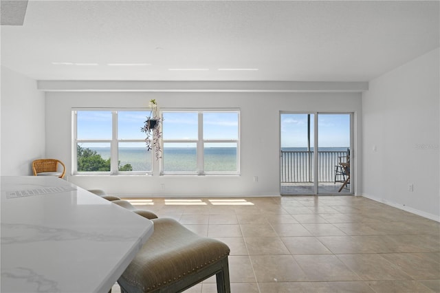 101 N Marion Ct Unit 133, Punta Gorda, FL 33950 - living room featuring baseboards, light tile patterned floors, and a water view