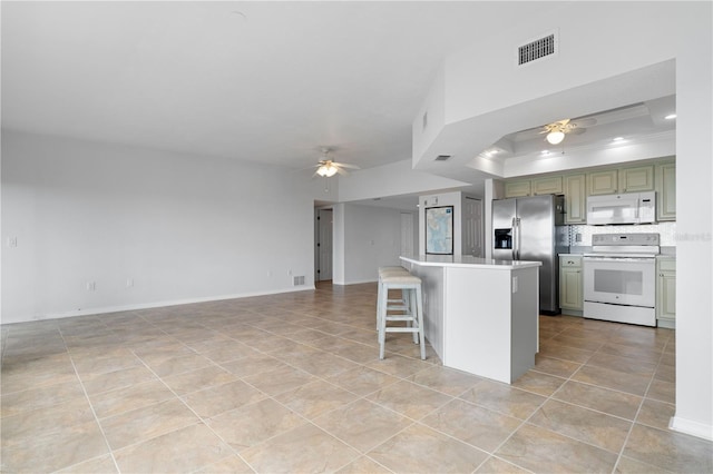 101 N Marion Ct Unit 133, Punta Gorda, FL 33950 - kitchen featuring white appliances, a ceiling fan, light tile patterned floors, crown molding, and a breakfast bar