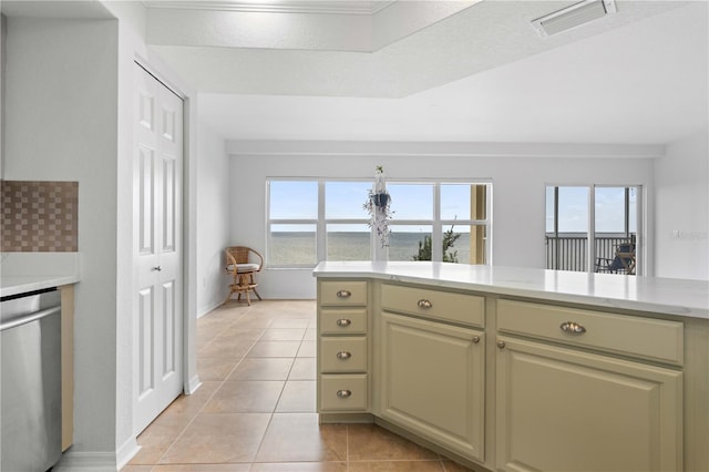 101 N Marion Ct Unit 133, Punta Gorda, FL 33950 - kitchen with stainless steel dishwasher, light countertops, light tile patterned floors, and cream cabinets