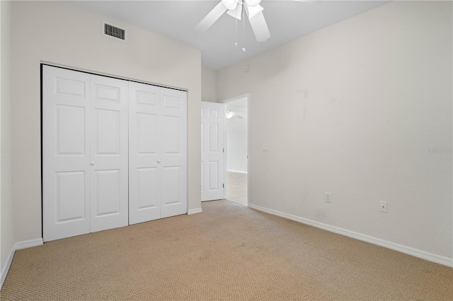 101 N Marion Ct Unit 133, Punta Gorda, FL 33950 - unfurnished bedroom with light carpet, a closet, baseboards, and a ceiling fan